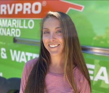 Female employee Brittani in front of SERVPRO truck