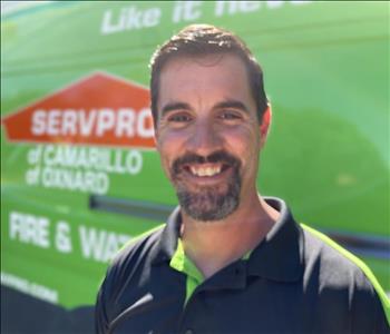 Portrait of male employee Jason in front of green truck